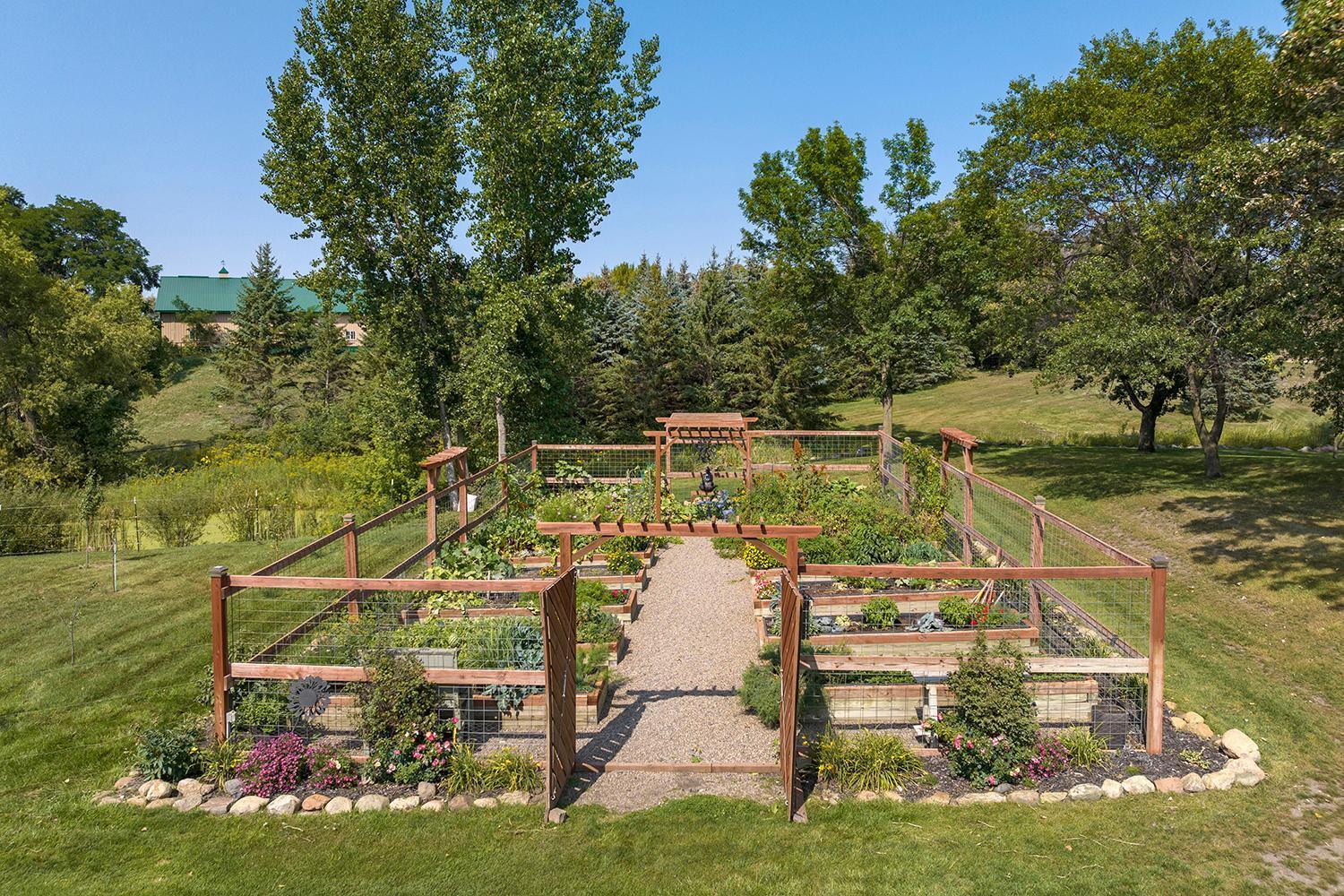 The self-watering organic garden is something most can only dream of – elevated beds, self-irrigation system, and high fencing to keep out deer and rabbits - all come together to create a low-maintenance and high producing outdoor garden!