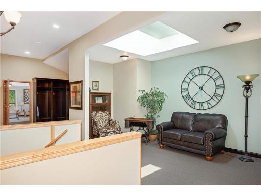 A small seating area and to the left is the staircase to the lower level