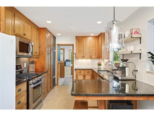 The kitchen has beautiful stone countertops and updated appliances in the private living quarters.