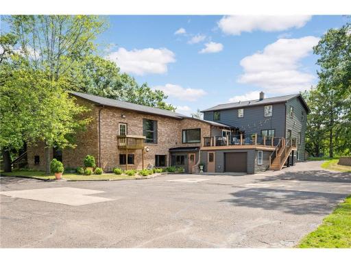 This shows the back of the residence with the maintenance free deck that overlooks the beautiful setting