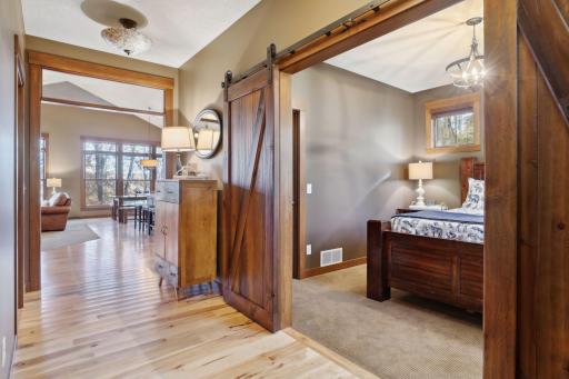 The spacious walk-in closet provides ample storage for your wardrobe, while stylish barn doors add a touch of rustic charm.