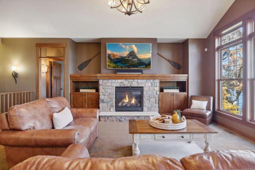 The vaulted amplifies openness, while the gas fireplace, with a natural stone surround creates a cozy atmosphere.
