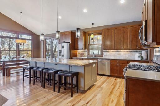 This beautifully appointed kitchen is a chefâs dream, blending style and functionality with warm knotty alder cabinets that offer generous storage solutions.