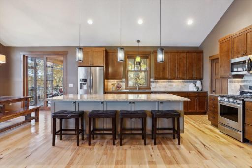 The centerpiece is a striking 10-foot island with a sleek granite countertop, complete with breakfast bar seating â ideal for morning coffee or casual meals.