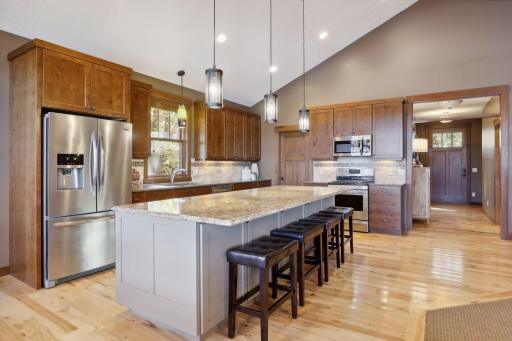 Expansive granite countertops offer plenty of room for meal prep, while the large pantry ensures everything is neatly organized.