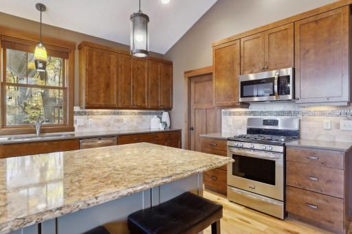 The island doubles as a prep space and social hub, ideal for setting out appetizers or enjoying morning coffee while overlooking the main living areas.