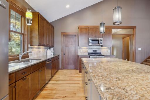 Open to the living and dining areas, this space keeps you connected to guests or family, making it easy to stay part of the conversation while you cook, serve, and enjoy.
