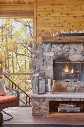 A wood-burning fireplace with a rock surround and built-in wood storage adds to the cozy feel, perfect for unwinding on crisp evenings.