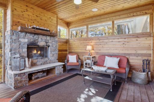 Embrace the ultimate lakeside retreat in this stunning screen porch, wrapped in rich tongue-and-groove cedar walls and ceiling creating a warm ambiance.