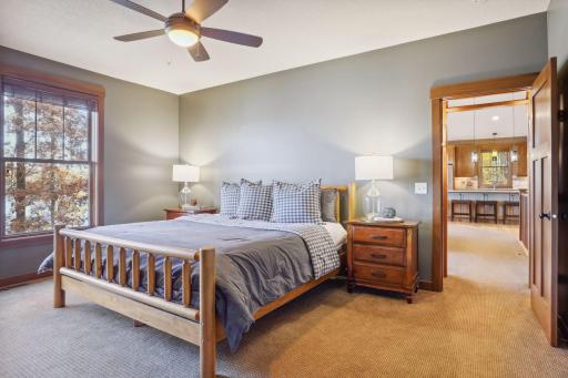 Nestled on the main level, this spacious primary suite serves as a tranquil retreat with serene views of Deer Lake.