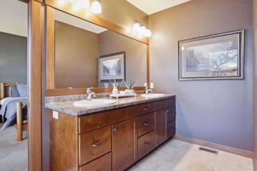 Step into this thoughtfully designed primary ensuite bath, where elegance and functionality meet. The dual bowl vanity provides ample room for each person to comfortably prepare for the day ahead.