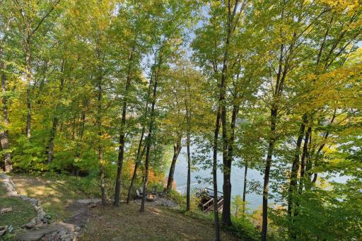 With steps leading to the firepit, lakeside deck, and private dock â these outdoor spaces are perfect for relaxing, entertaining, or enjoying the beauty of the lake throughout the seasons.