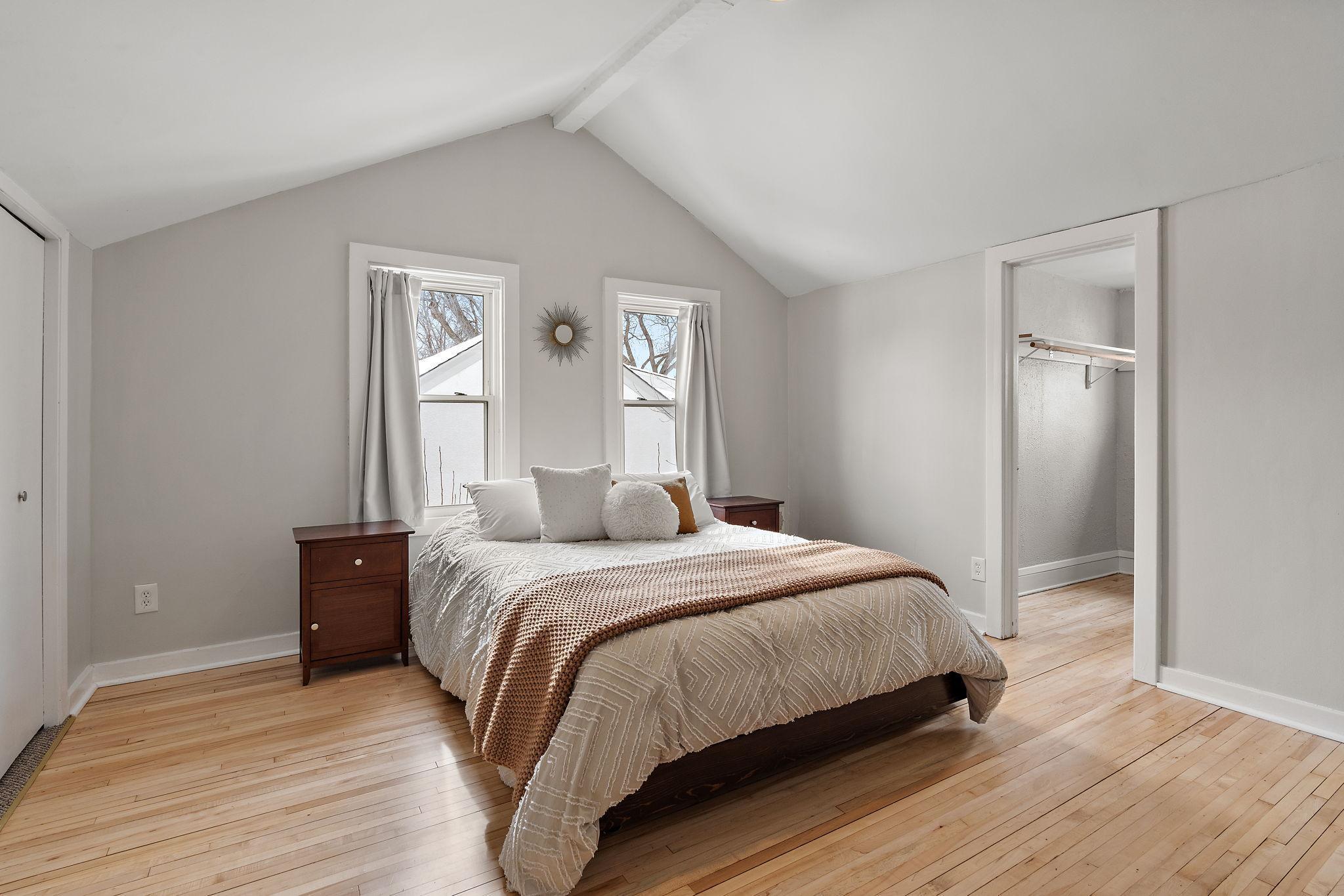 The oversized upper level primary bedroom feels spacious with vaulted ceilings.