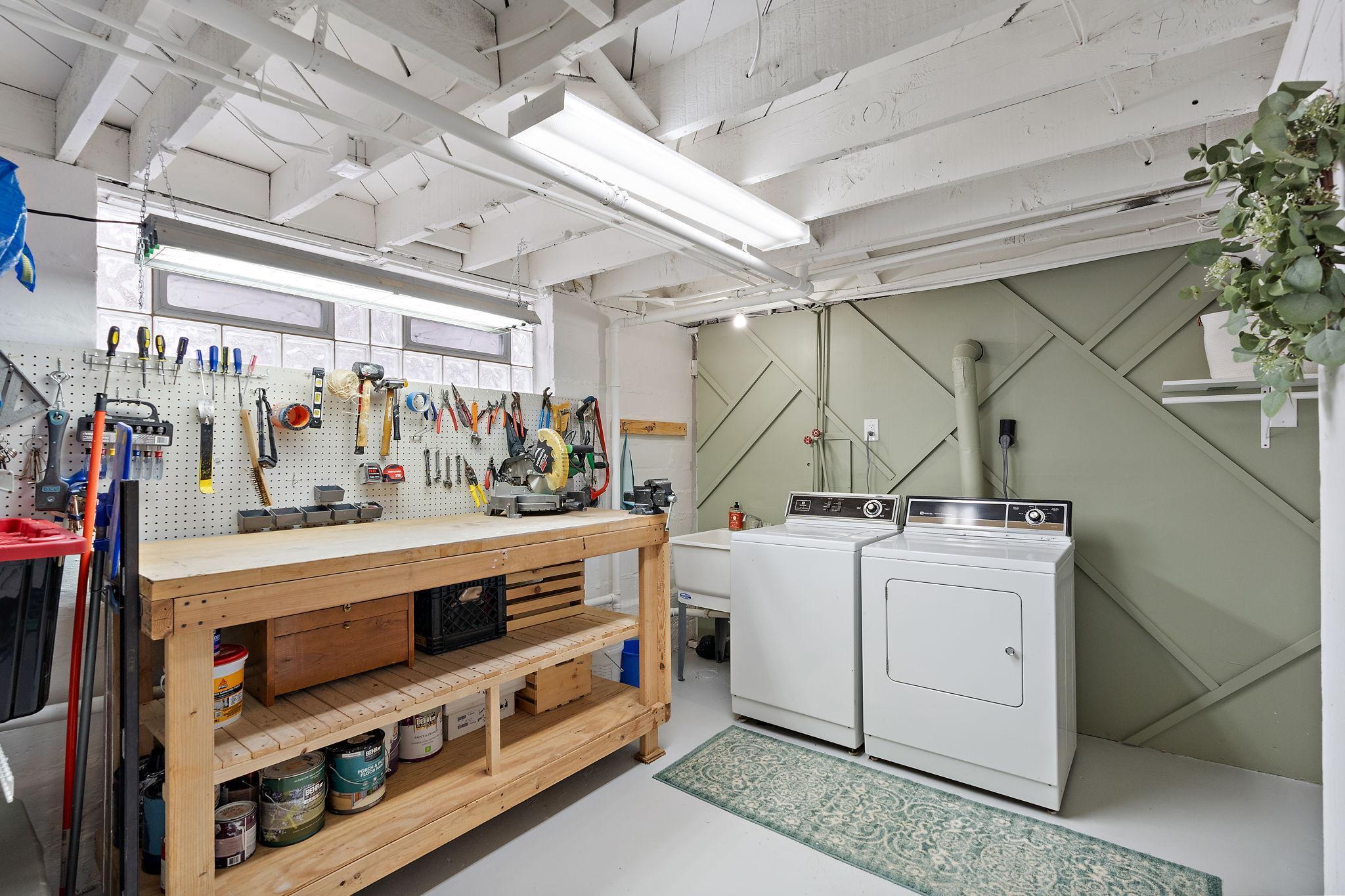 Lower level laundry room and workbench.