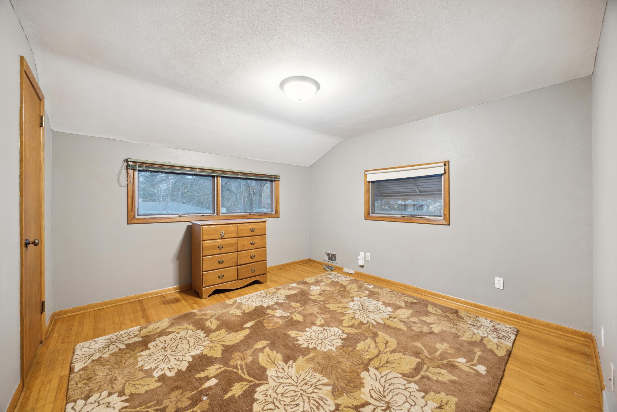 Second of 4 upper level bedrooms. Hardwood floors and a large closet.