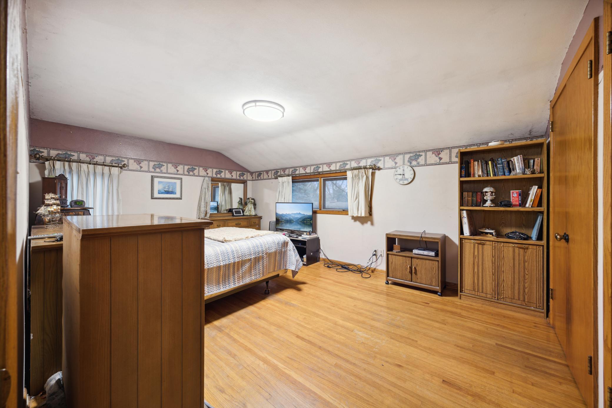 One of 4 upper level bedroom. This room is so large. The hardwood flooring is beautiful.