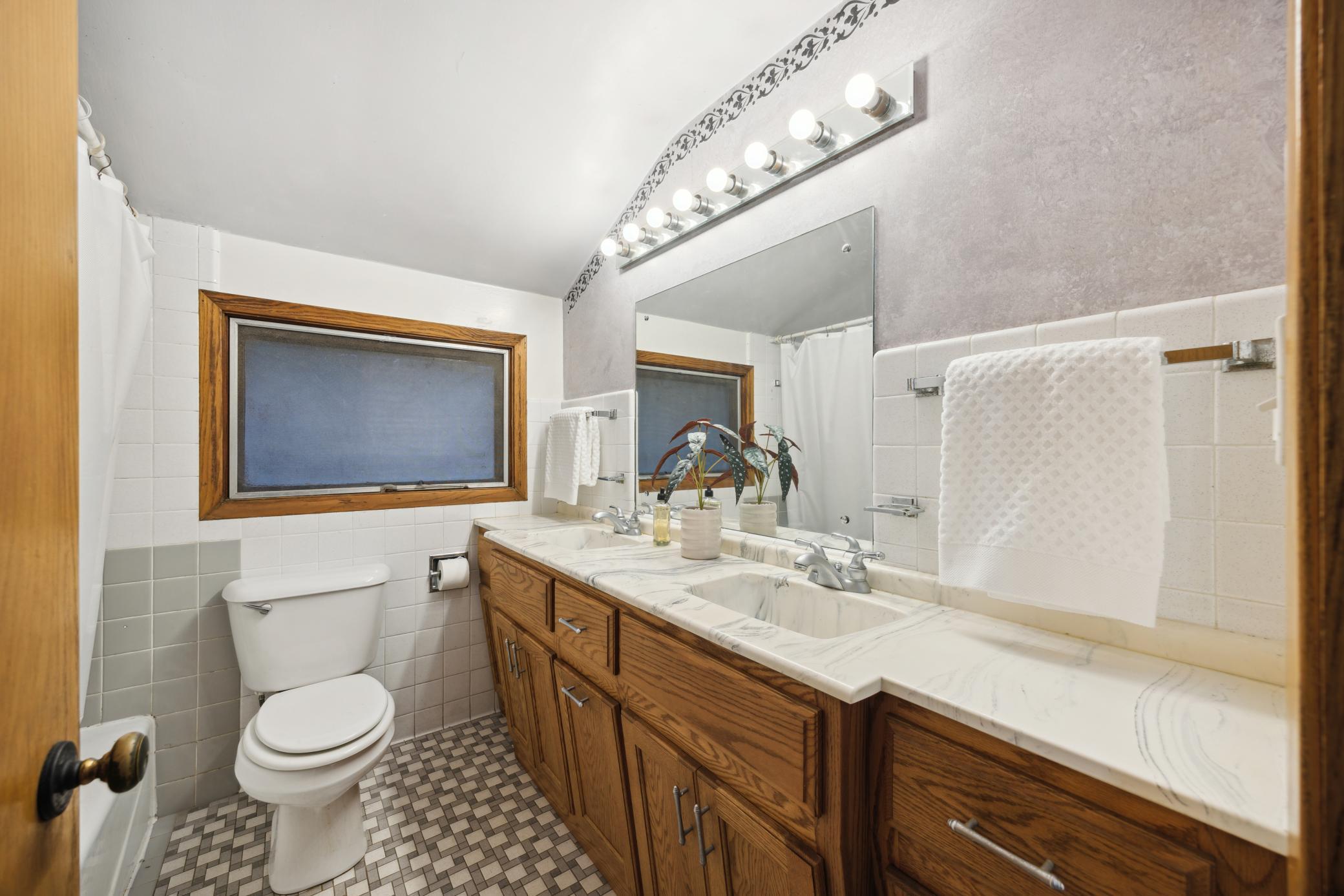 Upper level full bath with double sinks.