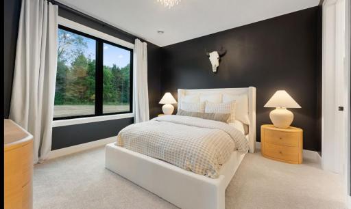 Serene ADU Primary bedroom features large windows overlooking rear yard.