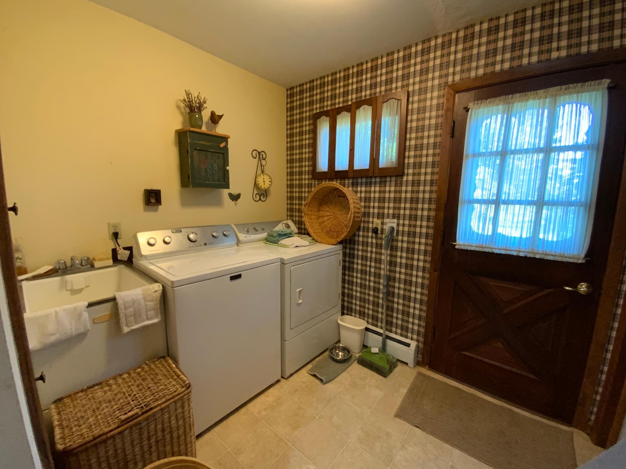 Laundry room with door to the backyard.
