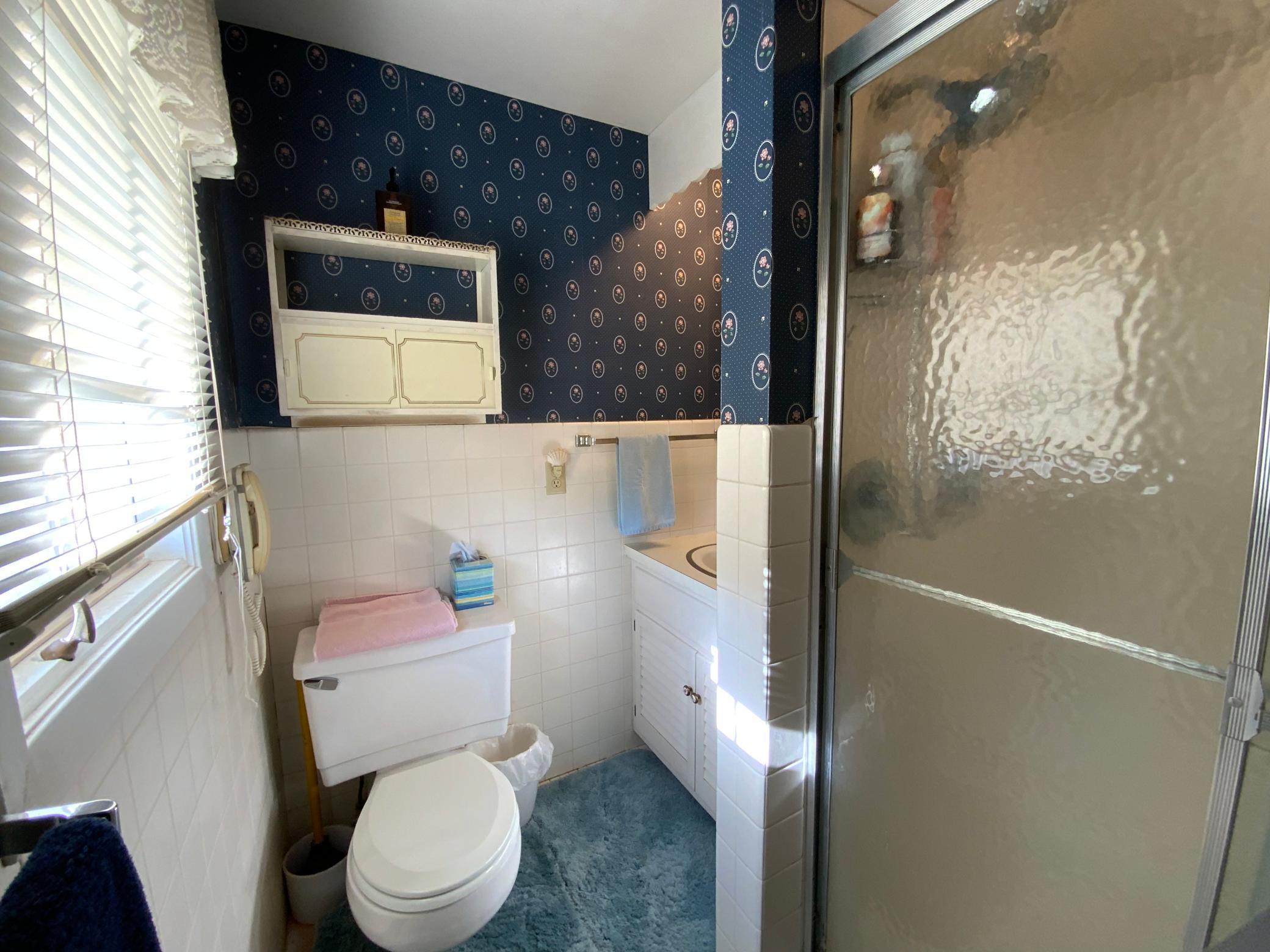 Primary bedroom with 3/4 bath ensuite including walk-in shower.