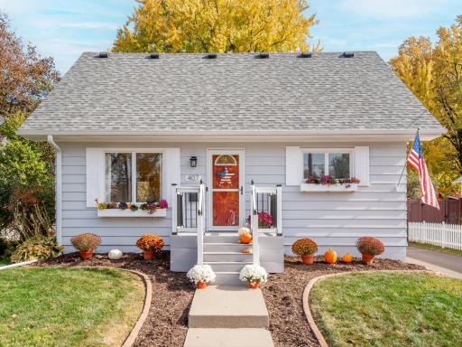 Front of home with newly update porch, window boxes and landscape