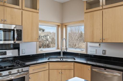 The kitchen features charming windows above the sink, filling the space with natural light and offering a delightful view.