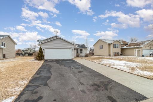 Cement sidewalk extended the length of the driveway. Garden storage shed built on the side of the home.
