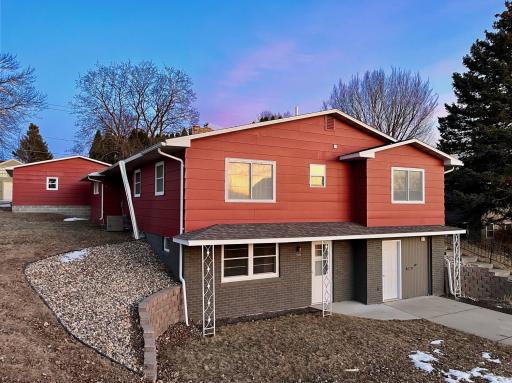 Welcome! Stately, well maintained & landscaped, red home!