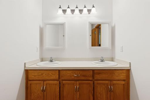 A door between the double sink vanity and toilet areas lend to extra privacy