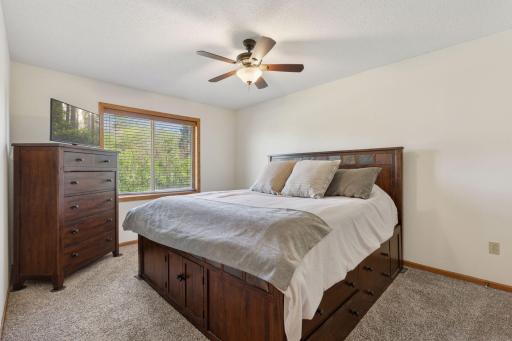 Spacious primary bedroom featuring a walk-in closet...