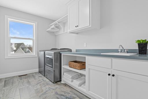 Upper level laundry with additional sink and storage space