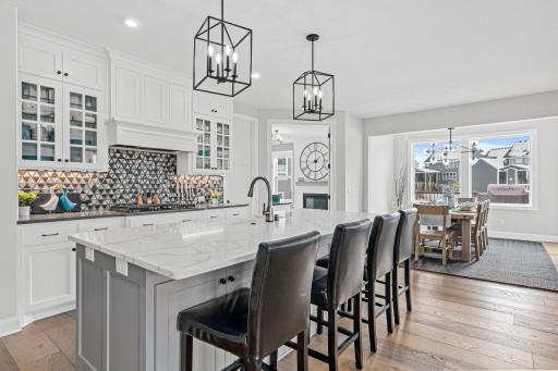 Luxury kitchen with elegant backsplash and see-through glass cabinetry