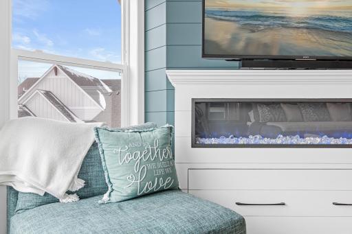 Primary with shiplap wall and gas fireplace