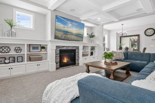 Gas fireplace, built in shelving and framed windows add ambiance to the open floor plan.