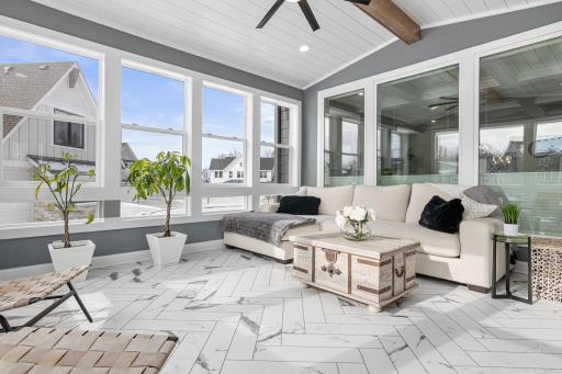 From the sleek flooring to the arched ceiling, this sunroom is a haven for relaxation