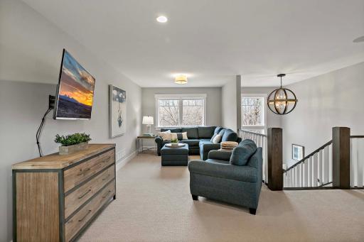 Bright and inviting upstairs living room, offering a cozy retreat with plenty of space for relaxation and entertainment.