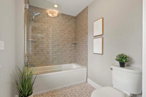 Stunning shower tiles and a stylish backsplash, adding a touch of elegance and sophistication to the space.