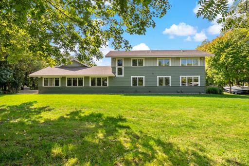A stunning view from the back of the house, featuring expansive windows that bring the outdoors in.