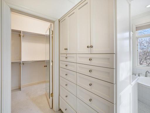 Primary walk-in closet has a lot of storage!