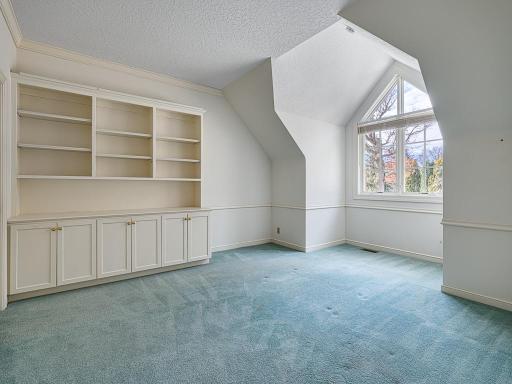 Upper level bedroom has ensuite bathroom, built-ins and a walk-in closet.