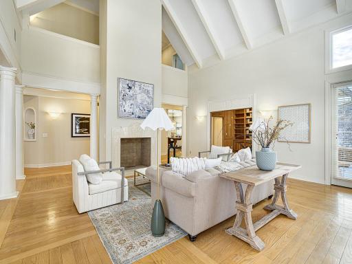 Spacious and airy living room with vaulted ceiling and a beautiful fireplace.