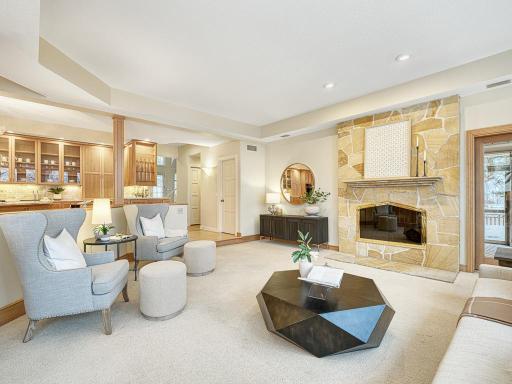 Generous family room with stone surround fireplace.