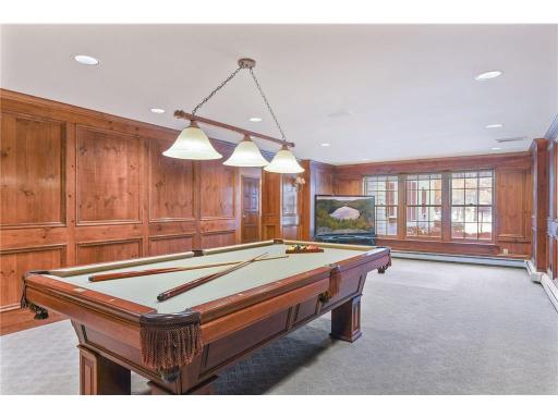 Lower level living room with large/floor to ceiling windows