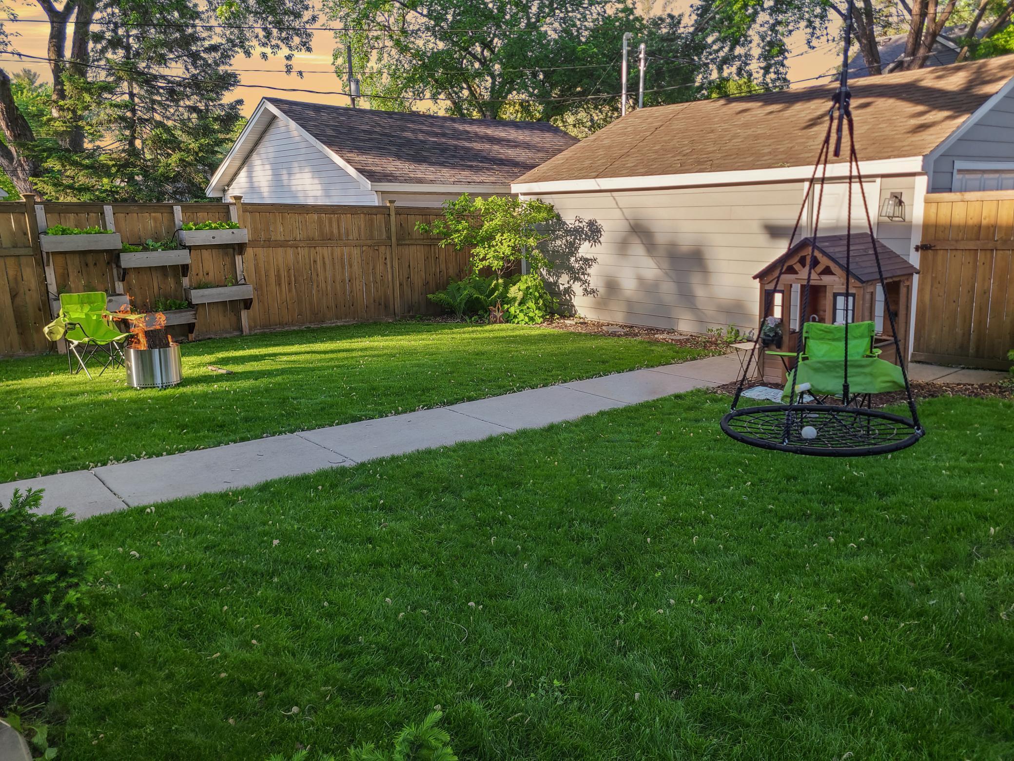 The back yard was brought to life using organic methods & all native plants, including rare perennial peonies along the house edge (not pictured).