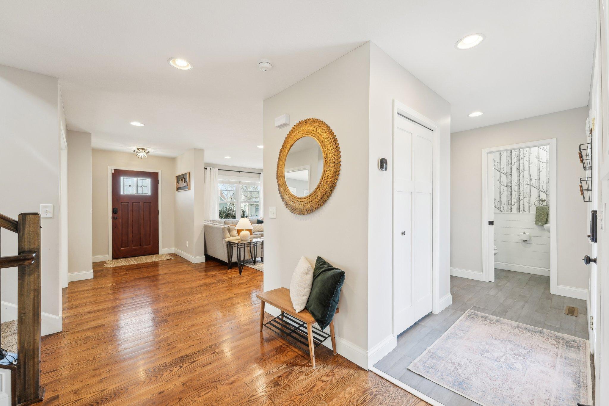 The rear entrance to the home walks into a mudroom that is paired with a convenient main level 1/2 bathroom.