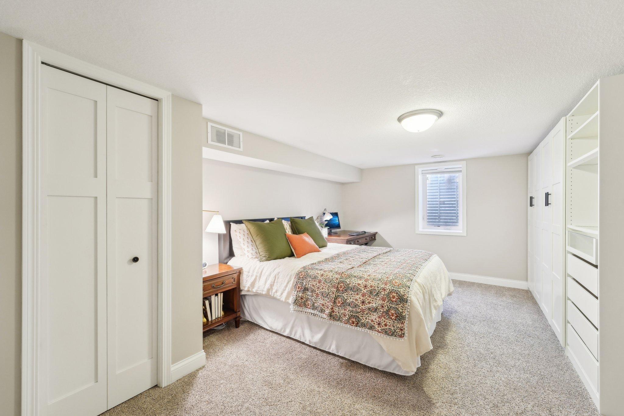 Lower level bedroom makes for the perfect guest room, as it's just across the hall from the bathroom. This room features dual closets and and a wall of built-ins for plenty of storage space!