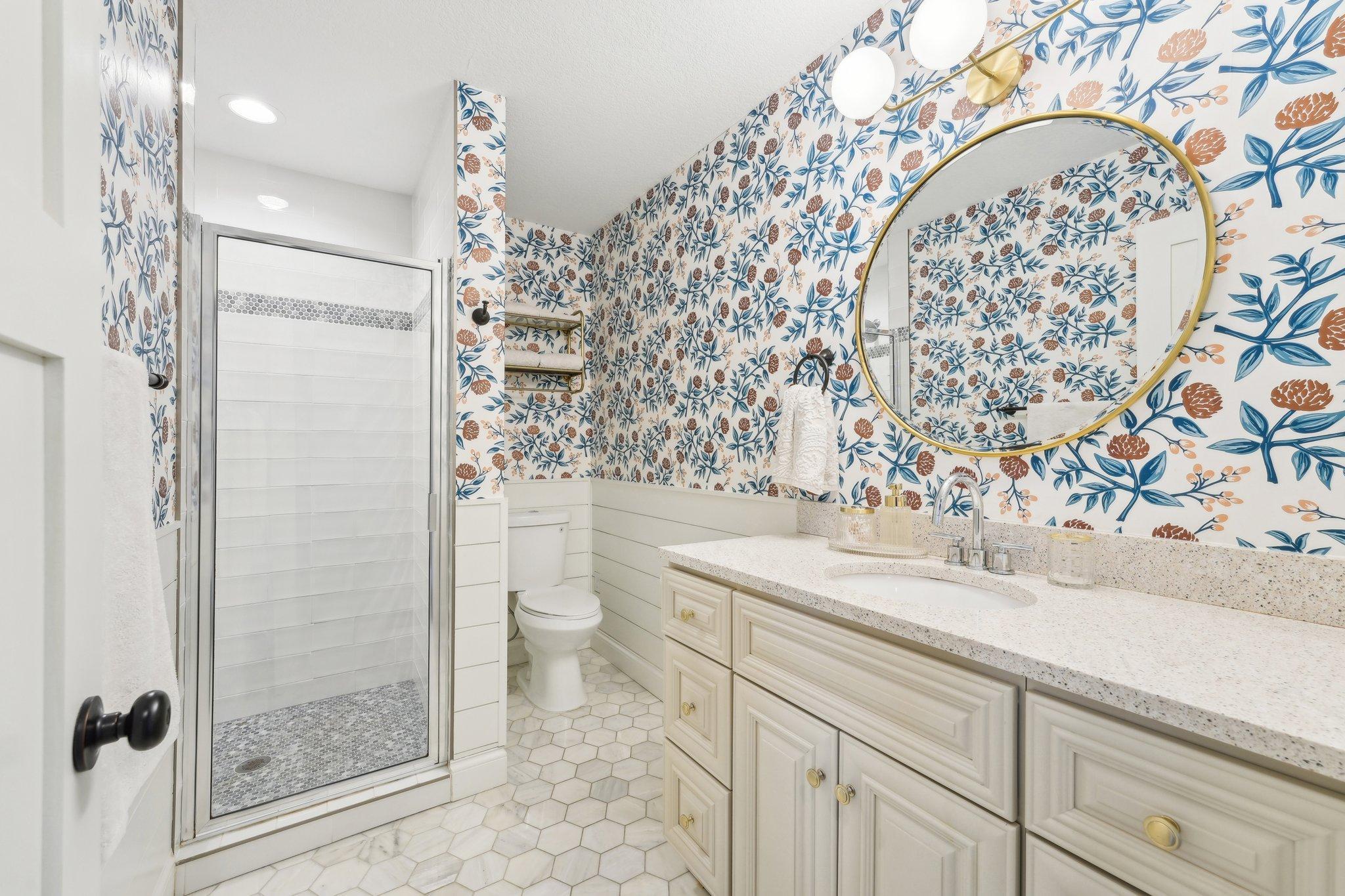 Primary suite private bathroom with gorgeous tile work and walk-in shower.
