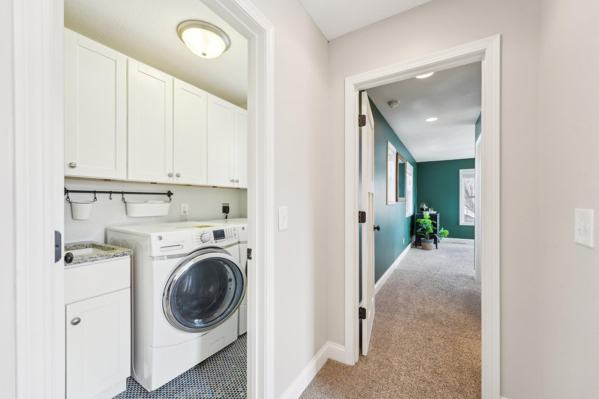 Bedroom-level laundry just outside the primary suite.