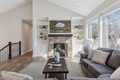 Cozy up by the main floor fireplace with soak in the lake views.