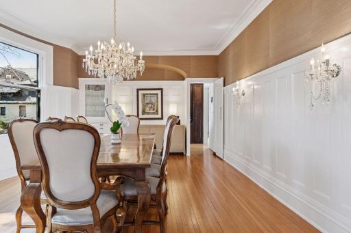 A generous formal dining room features large original windows overlooking the yard and gardens. Plenty of space for large gatherings. Built-in cabinetry and high wainscoting on walls.